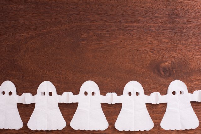 a line of paper chain halloween ghosts with space for text above
