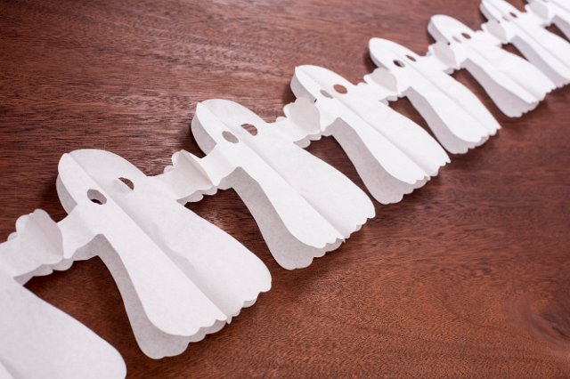 angled view of halloween ghost bunting on a wooden surface