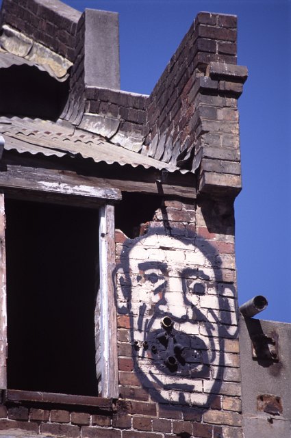 screaming head grafitti on a derelict building