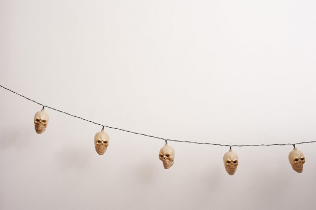 String of unlit white Halloween skull lights with copy space above for your festive greeting