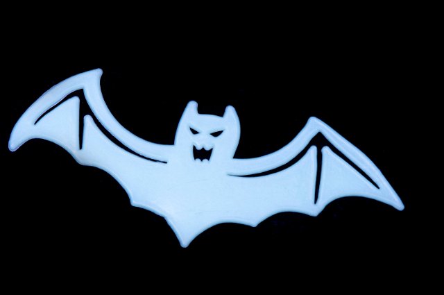 a blue halloween bat shape decoration on black background