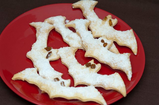 a plate of cookies shaped like bats for a halloween childrens party