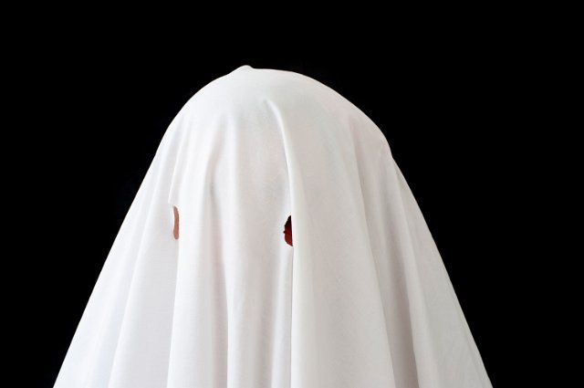 homemade halloween ghost costume made from a white bed sheet