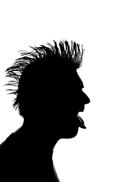 silhouette of a man with a mohawk hair cut and tongue sticking out