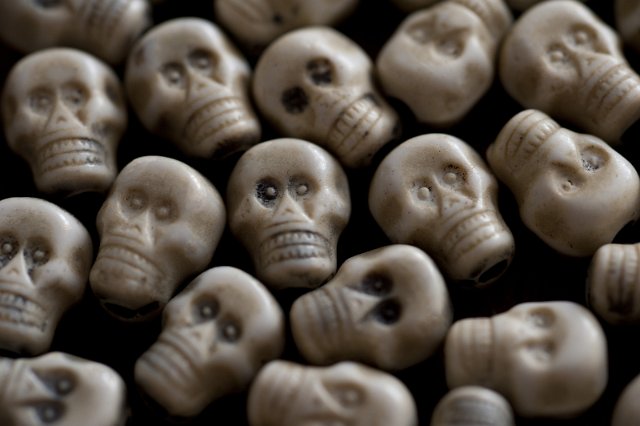 Close up on little plastic skulls as full frame background about Halloween or other frightening concepts